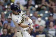 Milwaukee Brewers' Eric Lauer hits an RBI- sacrifice fly during the second inning of a baseball game against the Cincinnati Reds, Monday, June 14, 2021, in Milwaukee. (AP Photo/Aaron Gash)