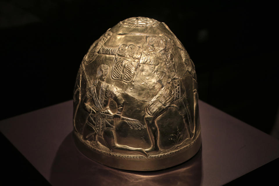 A Scythian gold helmet from the fourth century B.C. is displayed as part of the exhibit called The Crimea - Gold and Secrets of the Black Sea, at Allard Pierson historical museum in Amsterdam Friday April 4, 2014. The museum has gotten more than the bronze swords, golden helmets and precious gems it bargained for as it is unsure where to return the collection after Russia annexed Crimea. (AP Photo/Peter Dejong)