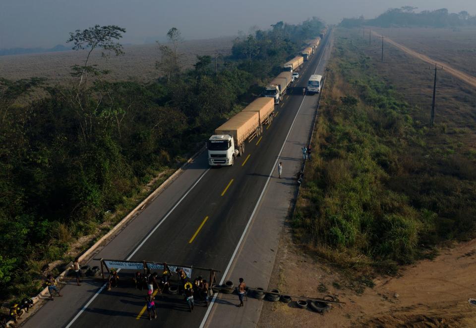 Indigenous protestors in Brazil block a major Trans-Amazonian highway to protest against the lack of governmental support during the COVID-19 pandemic and illegal deforestation in and around their territories. / Credit: JOAO LAET/AFP via Getty Images