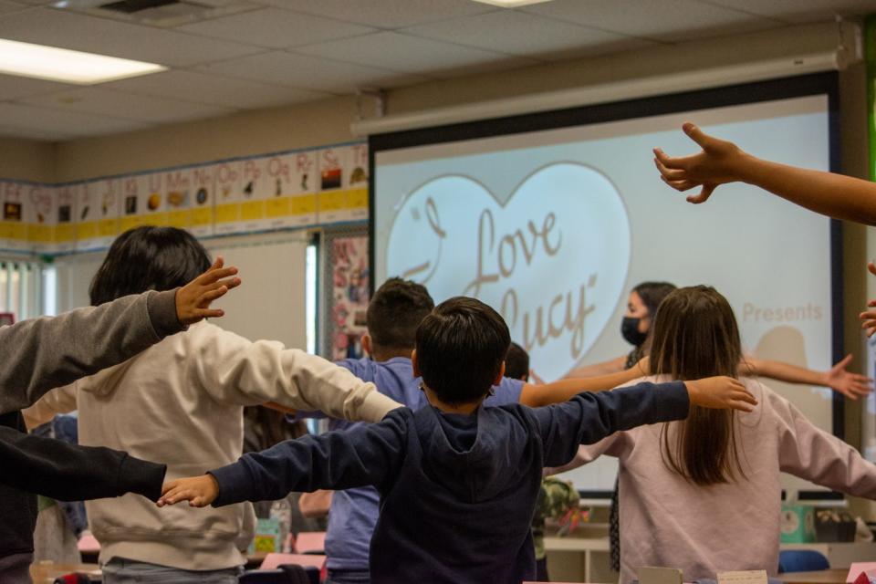 Fourth-grade students stretch before a lesson taught with "I Love Lucy" at Cathedral City Elementary in Cathedral City, on Tuesday, March 8, 2022.