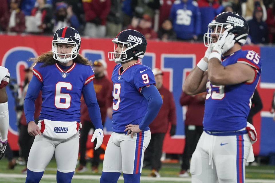 New York Giants kicker Graham Gano, center, looks after his field goal during overtime of an NFL football game against the Washington Commanders, Sunday, Dec. 4, 2022, in East Rutherford, N.J. The kick missed and the game ended in a tie. (AP Photo/John Minchillo)