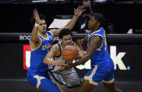 UCLA guard Jules Bernard (1) and UCLA guard David Singleton (34) pressure Oregon guard Will Richardson (0) during the second half of an NCAA college basketball game Wednesday, March 3, 2021, in Eugene, Ore. (AP Photo/Andy Nelson)