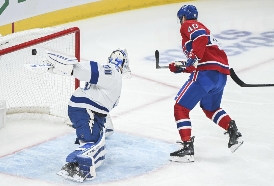 Montreal Canadiens' Joel Armia (40) scores against Tampa Bay Lightning goaltender Matt Tomkins, left, during first-period NHL hockey game action in Montreal, Thursday, April 4, 2024. (Graham Hughes/The Canadian Press via AP)