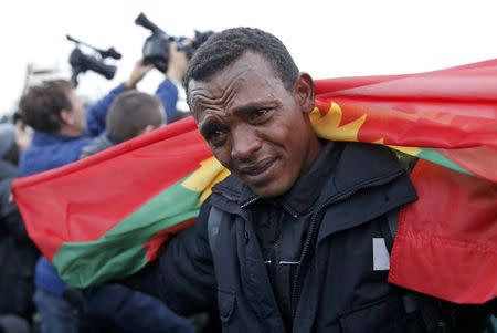 An Ethiopian migrant, member of the Oromo community, cries as he leaves the "Jungle" to be transfered to reception centers during the start of the dismantlement of the camp in Calais, France, October 24, 2016. REUTERS/Pascal Rossignol