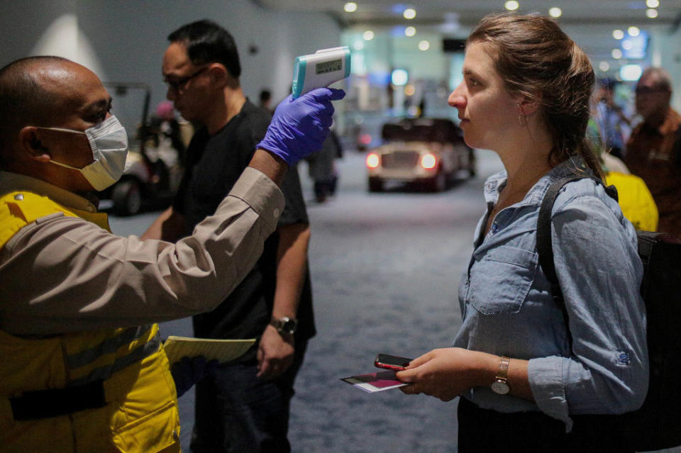 Health officer uses a thermal head to detect a monkeypox virus on arriving passengers at Soekarno-Hatta International Airport in Tangerang near Jakarta. Source: Getty