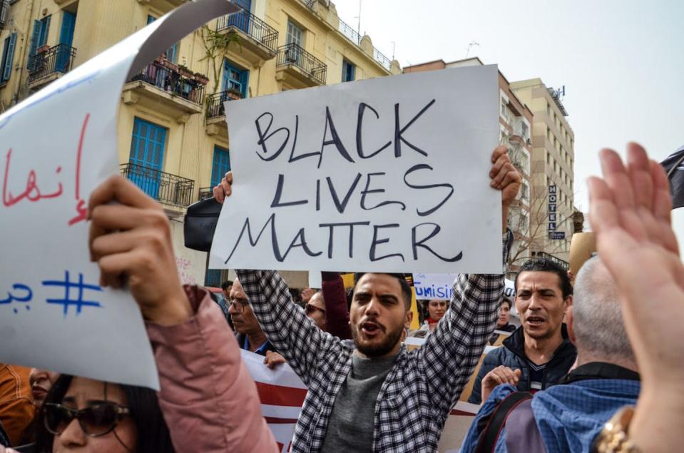 Tunisians demonstrate against racism during a protest in Tunis on Feb. 25, 2023. <a href="https://www.gettyimages.com/detail/news-photo/tunis-tunisia-25-february-2023-a-man-holding-a-sign-that-news-photo/1470231559?adppopup=true" rel="nofollow noopener" target="_blank" data-ylk="slk:Hasan Mrad/DeFodi Images via Getty Images;elm:context_link;itc:0;sec:content-canvas" class="link ">Hasan Mrad/DeFodi Images via Getty Images</a>