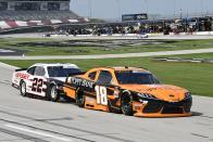 Daniel Hemric (18) leads Austin Cindric (22) into Turn 1 during a NASCAR Xfinity Series auto race at Texas Motor Speedway in Fort Worth, Texas, Saturday, June 12, 2021. (AP Photo/Larry Papke)