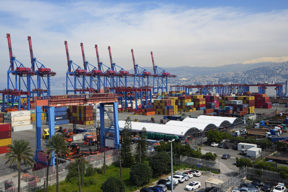 Gantry cranes move containers onto transporters at the Beirut Port, in Beirut, Lebanon, Wednesday, March 13, 2024. Three and a half years after hundreds of tons of improperly stored ammonium nitrate ignited at the Beirut port, setting off one of the world's biggest non-nuclear explosions, Lebanese and French officials put forward a plan for reconstruction and reorganization of the port Wednesday. (AP Photo/Bilal Hussein)