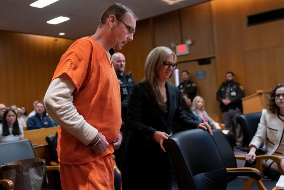 James Crumbley, left, enters court as he prepares to sit with his attorney Mariell Lehman before Jennifer Crumbley, sits with her attorney Shannon Smith in the Oakland County courtroom of Cheryl Matthews on Tuesday, April 9, 2024 for sentencing.