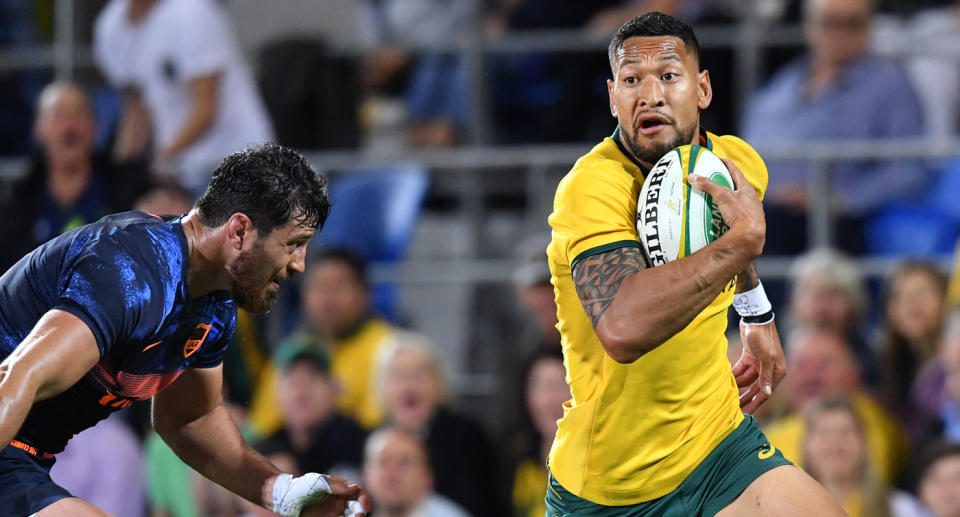 Israel Folau (right) of the Wallabies makes a break to score a try in the corner during the Rugby Championship match between Australia and Argentina at Cbus Super Stadium on the Gold Coast in 2018. Folau's GoFundMe page has been taken down as he seeks legal action against Rugby Australia. 