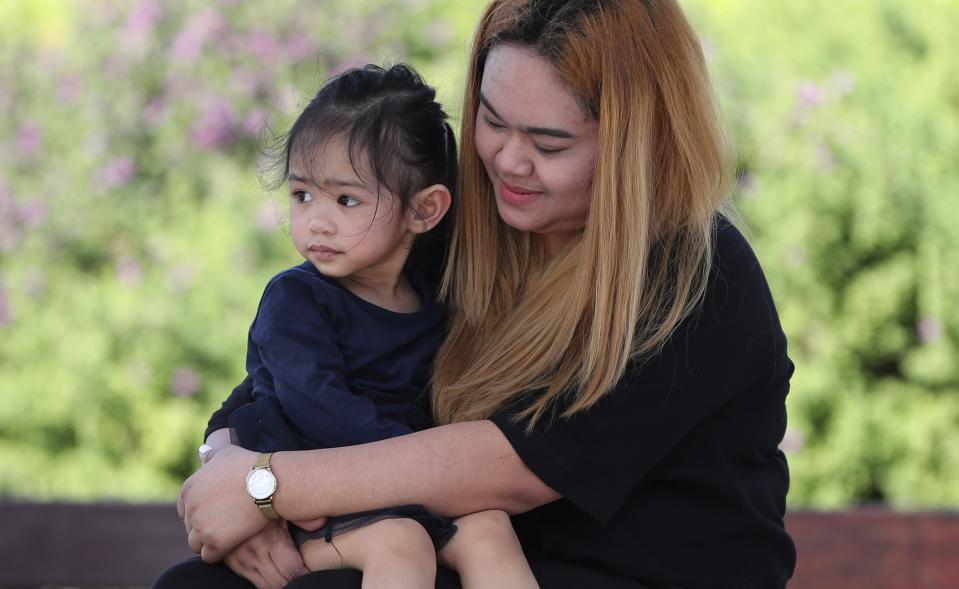 Sitte Honey, 25, holds her two-year-old undocumented daughter Naya at a park in Dubai, United Arab Emirates, Tuesday, Nov. 23, 2021. A year after the United Arab Emirates decriminalized premarital sex in a bold expansion of personal freedoms, the law has struggled to fulfill its promise. Unwed mothers may no longer land in jail, but they're caught in bureaucratic limbo, fighting to obtain birth certificates for their babies born in the shadows. (AP Photo/Kamran Jebreili)