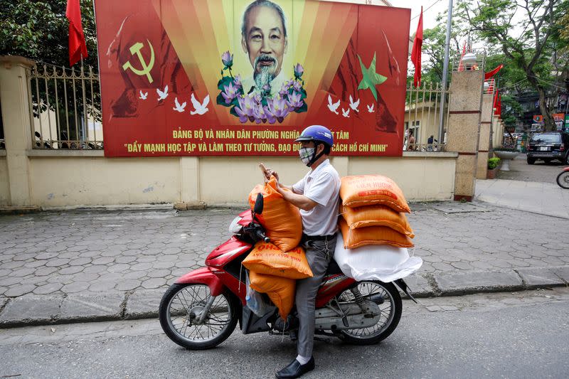 FILE PHOTO: A donor carries rice bags to contribute to poor people during coronavirus disease (COVID-19) outbreak in Hanoi