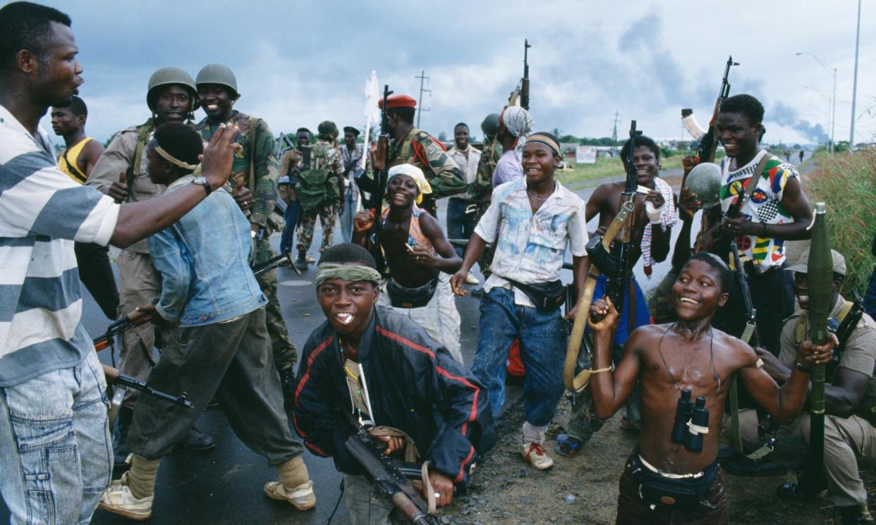 <span>Rebel fighters pose with soldiers from the west African peacekeeping force, Ecomog, in Monrovia in 1992, during Liberia’s first civil war.</span><span>Photograph: Patrick Robert/Corbis/Sygma/Getty Images</span>