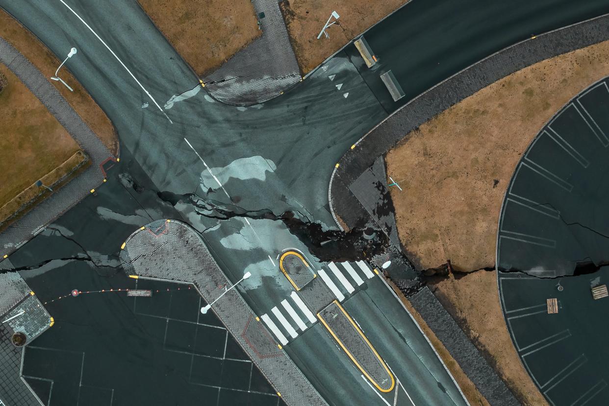 This image taken with a drone shows cracks at an intersection in the town of Grindavik, Iceland (AP)