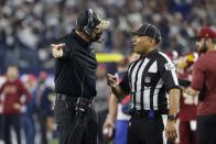 Washington Football Team head coach Ron Rivera, left, argues with down judge Patrick Holt (106) after a Dallas Cowboys touchdown in the first half of an NFL football game in Arlington, Texas, Sunday, Dec. 26, 2021. (AP Photo/Michael Ainsworth)