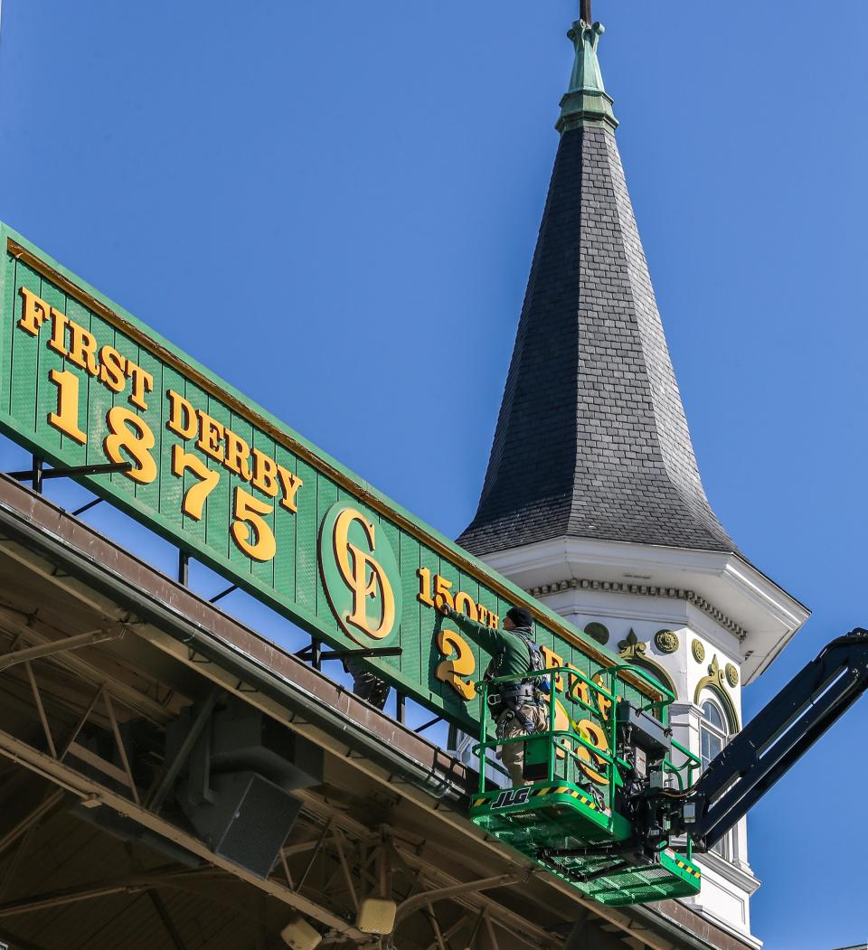 Todd Herl and Corey McGreal change the sign over the tunnel at Churchill Downs to 2024 and 150th Kentucky Derby on Tuesday, March 19, 2024