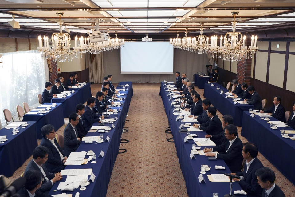 CORRECTS COMPANY NAME TO TOYOTA MOTOR CORP. - Japanese Trade Minister Isshu Sugawara meets with a group of the Japanese automakers chiefs including Akio Toyoda, president and CEO of Toyota Motor Corp., Thursday, Sept. 26, 2019, in Tokyo. The U.S. and Japan on Wednesday signed a limited trade deal that will eliminate tariffs and expand market access on farm, industrial and digital products. But the deal does not address autos, a key sticking point during months of contentious negotiations, and President Donald Trump indicated the two countries were still working on a broader agreement. (AP Photo/Eugene Hoshiko)