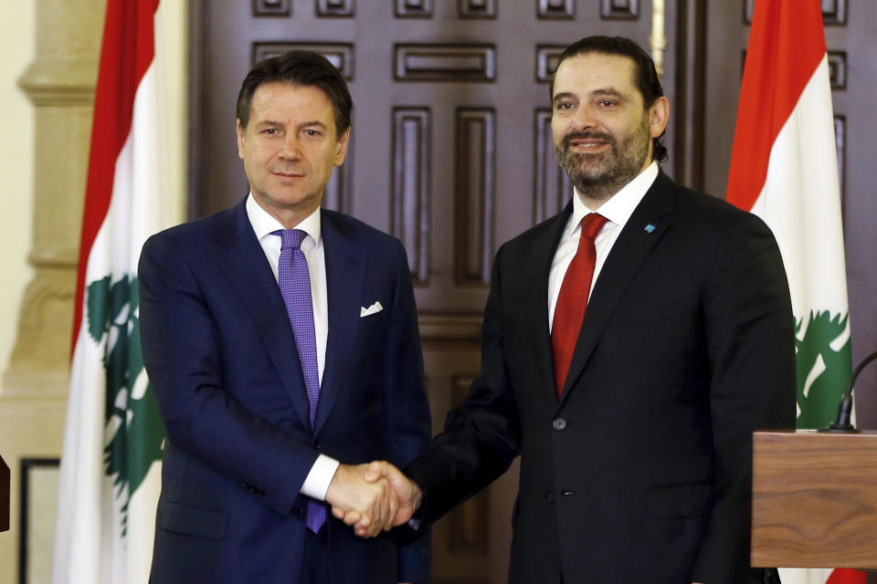 Italian Prime Minister Giuseppe Conte, left, shakes hands with his Lebanese counterpart Saad Hariri after a joint press conference, at the Government House in Beirut, Lebanon, Thursday, Feb. 7, 2019. (AP Photo/Bilal Hussein)