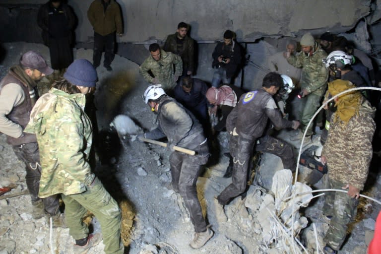 Syrian civil defence volunteers, known as the White Helmets, dig through the rubble of a mosque following a US air strike on the village of Al-Jineh late on March 16, 2017