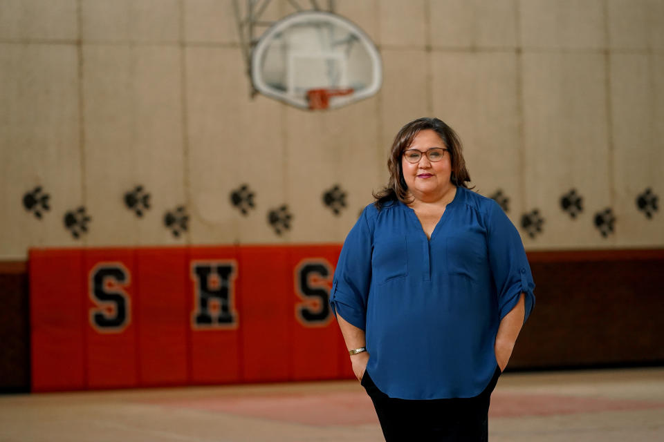 Superior Mayor Mila Besich stands in the gymnasium of the vacant Superior High School, Friday, June 9, 2023, in Superior, Ariz. Growing up in the historic mining town of Superior, Besich knew Oak Flat as the place she picnicked as a girl and listened to the World Series over clear radio signals in a clearing. Today, it is the subject of a tug of war between townspeople who want a huge copper mine built there for its economic benefits, and Native American groups that say the land is sacred and should be protected. (AP Photo/Matt York)