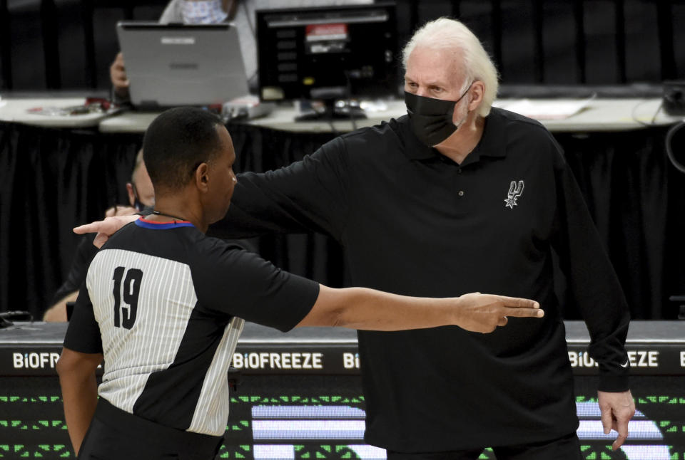 San Antonio Spurs head coach Gregg Popovich, right, has words with referee James Capers, left, during the second half of an NBA basketball game against the Portland Trail Blazers in Portland, Ore., Monday, Jan. 18, 2021. (AP Photo/Steve Dykes)