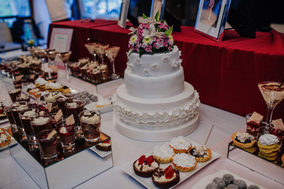 A wedding cake and other small desserts