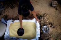 Atiele Santos, of the Karipuna indigenous people, prepares flour at the Ahuma village, near the mouth of the Amazon in Oiapoque