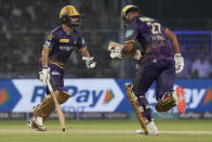 Kolkata Knight Riders' Rinku Singh, left, and captain Nitish Rana run between the wickets to score during the Indian Premier League cricket match between Kolkata Knight Riders and Sunrisers Hyderabad in Kolkata, India, Friday, April 14, 2023. (AP Photo/Bikas Das)