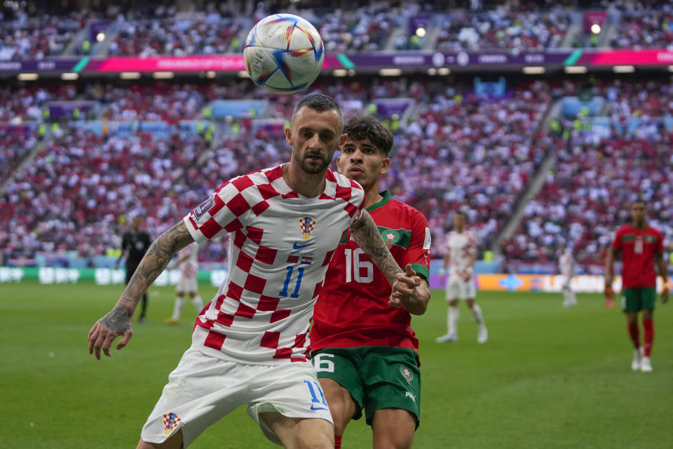 Croatia's Marcelo Brozovic, left, defends a ball against Morocco's Abde Ezzalzouli during the World Cup group F soccer match between Morocco and Croatia, at the Al Bayt Stadium in Al Khor , Qatar, Wednesday, Nov. 23, 2022. (AP Photo/Thanassis Stavrakis)