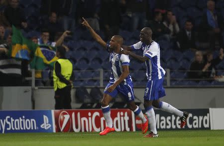 Porto's Yacine Brahimi (L) celebrates his goal with his teammate Bruno Martins during their Champions League Group H soccer match against BATE Borisov at Dragao stadium in Porto September 17, 2014. REUTERS/Rafael Marchante