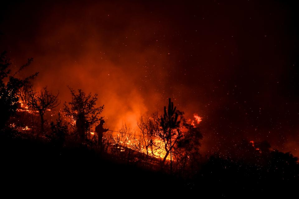 A firefighter tackles a wildfire at Amendoa in Macao, central Portugal on July 21, 2019. (Photo: Patricia De Melo Moreira/AFP/Getty Images)