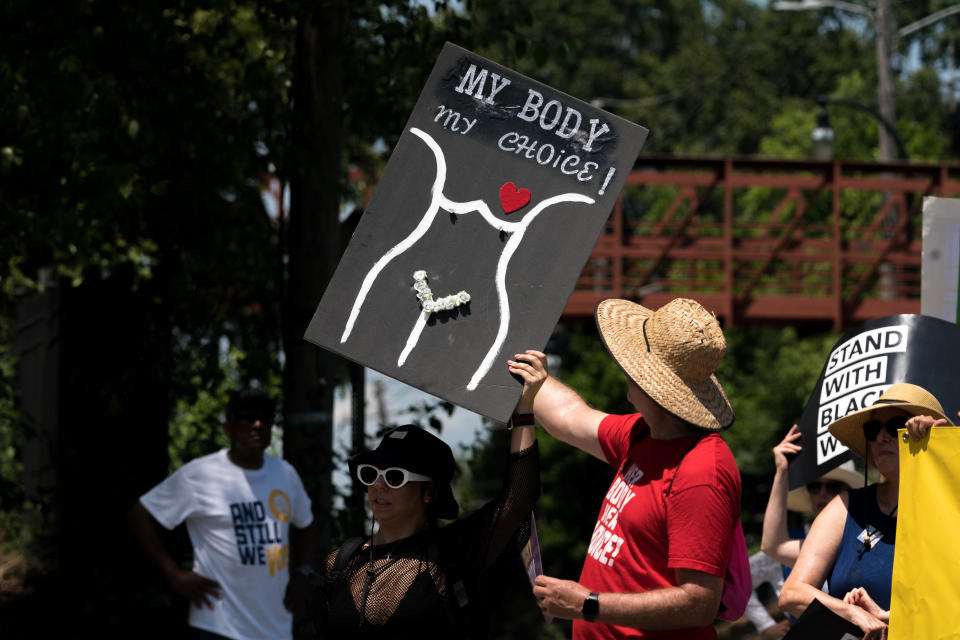 Pro-abortion-rights protesters, one holding a sign that says: My Body My Choice.