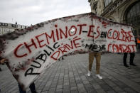 Rail workers demonstrate during a mass strike in Lille, northern France, Tuesday Dec. 10, 2019. The strikes are a big test for French President Emmanuel Macron, who promised to reform France's retirement system and keep the pension system from sinking in debt, but unions fear the changes erode their hard-won worker protections. Banner reads: "Angry railway worker, private and public same fight".(AP Photo/Michel Spingler)