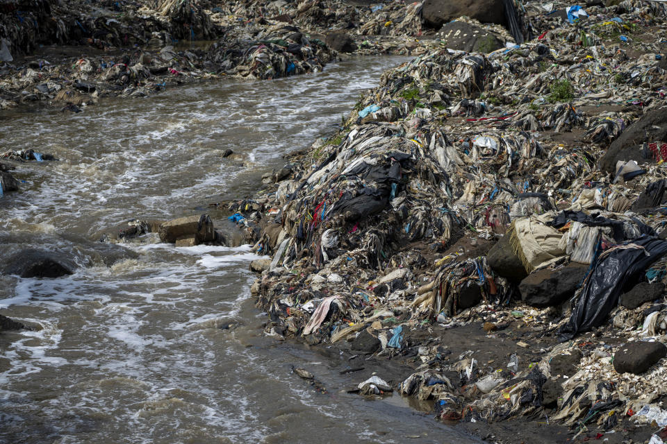 Plastic bottles and waste float pollute the Las Vacas river in Chinautla, on the outskirts of Guatemala City, Wednesday, June 8, 2022. The Ocean Cleanup NGO is currently piloting a trash collection device in one of the world's most polluted rivers, the Las Vacas river, where unique seasonal challenges include huge quantities of waste and massive water pressure during the rainy season. (AP Photo/Moises Castillo)