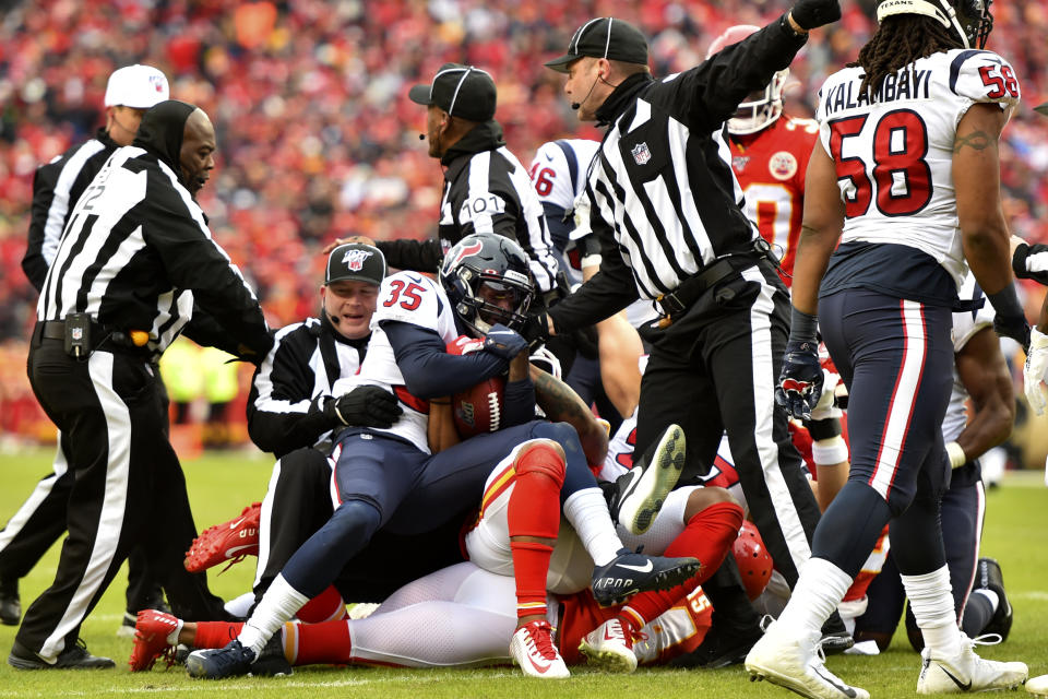 Houston Texans cornerback Keion Crossen (35) recovers the ball fumbled on a punt ball by Kansas City Chiefs wide receiver Tyreek Hill during the first half of an NFL divisional playoff football game, in Kansas City, Mo., Sunday, Jan. 12, 2020. (AP Photo/Ed Zurga)