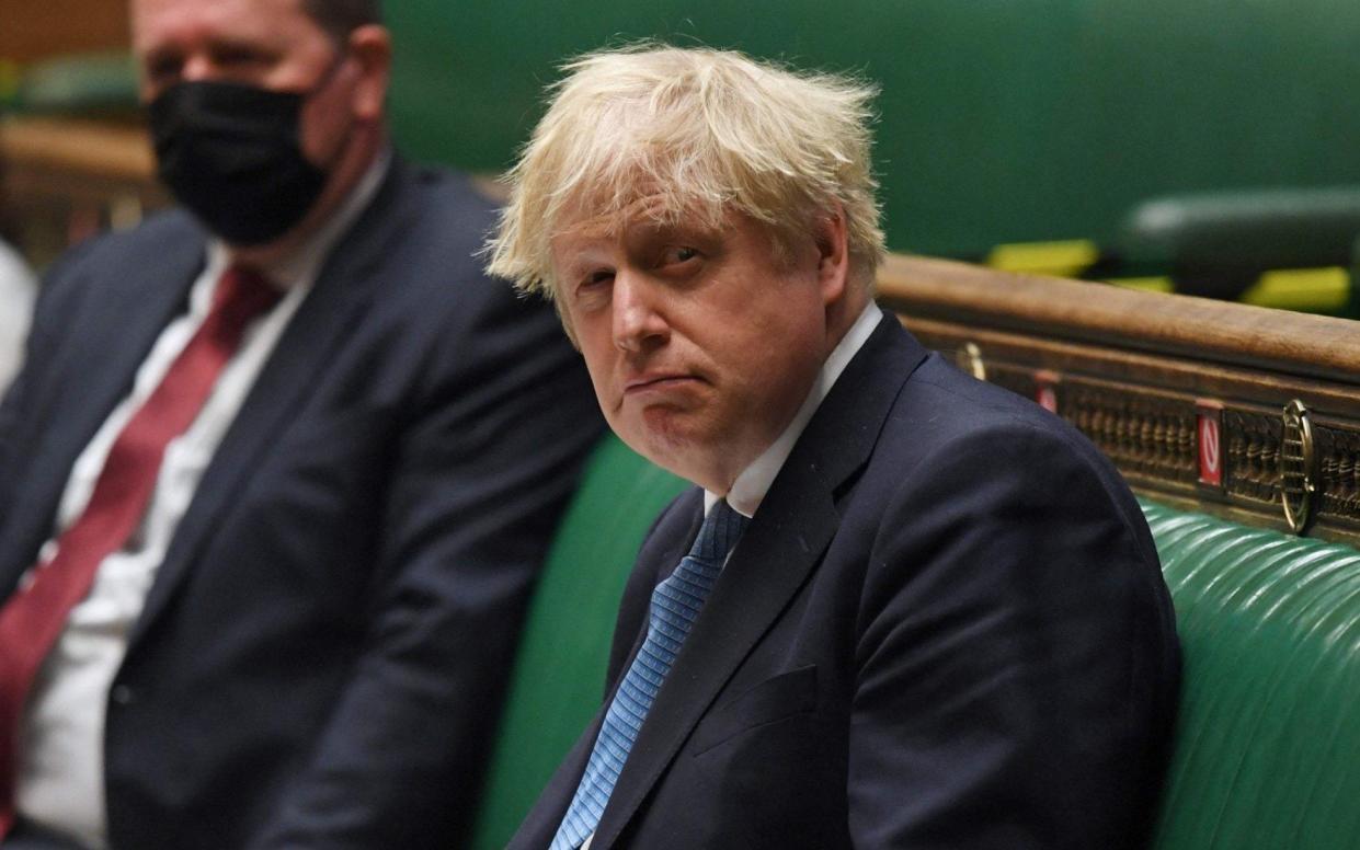 A handout photograph released by the UK Parliament shows Britain's Prime Minister Boris Johnson (R) updating MPs on the Covid-19 pandemic - JESSICA TAYLOR/AFP