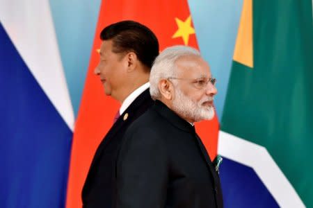 FILE PHOTO: Chinese President Xi Jinping (L) and Indian Prime Minister Narendra Modi attend the group photo session during the BRICS Summit at the Xiamen International Conference and Exhibition Center in Xiamen, Fujian Province, China September 4, 2017. REUTERS/Kenzaburo Fukuhara/Pool/File Photo