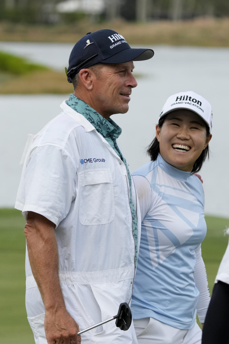Nasa Hataoka, right, of Japan, walks off the 18th green with her caddie, left, Gregory Johnston, during the first round of the LPGA CME Group Tour Championship golf tournament, Thursday, Nov. 16, 2023, in Naples, Fla. (AP Photo/Lynne Sladky)