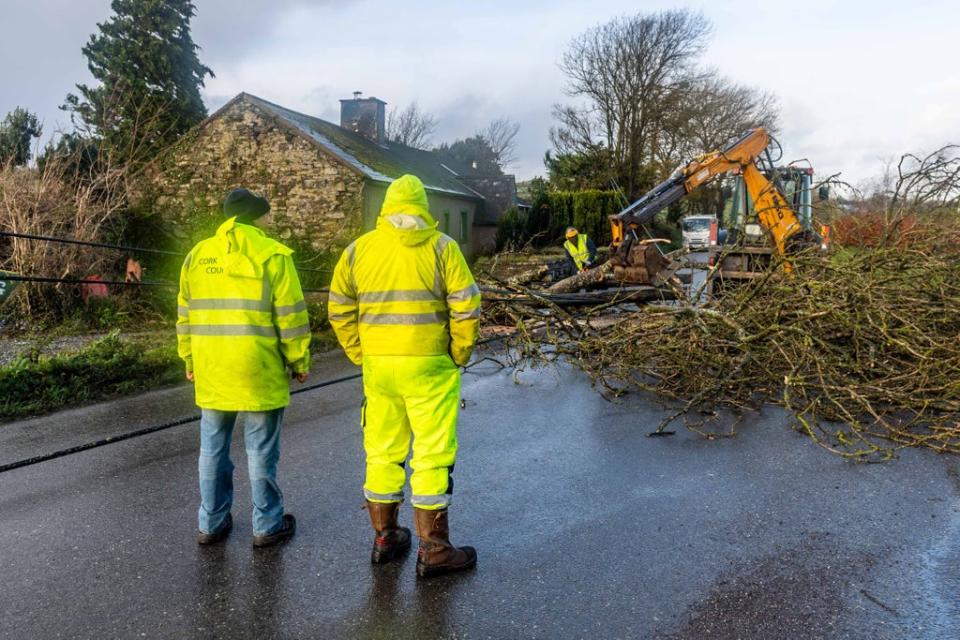 Cork County Council and ESB employees help to clear the road and restore power in Timoleague, West Cork (Andy Gibson/PA) (PA Wire)