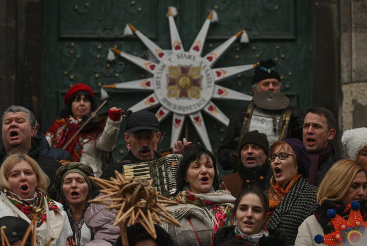 Singers in Lviv, Ukraine, before the traditional Christmas Stars Parade during Orthodox Christmas in January 2023. <a href="https://www.gettyimages.com/detail/news-photo/participants-sing-outside-the-church-of-the-holy-eucharist-news-photo/1246086484?adppopup=true" rel="nofollow noopener" target="_blank" data-ylk="slk:Artur Widak/Anadolu Agency via Getty Images;elm:context_link;itc:0;sec:content-canvas" class="link ">Artur Widak/Anadolu Agency via Getty Images</a>