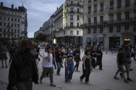 People gather in Lyon, central France, to protest the far-right National Rally, which came out strongly ahead in first-round legislative elections, Sunday, June 30, 2024. France's high-stakes legislative elections propelled the far-right National Rally to a strong but not decisive lead in the first-round vote Sunday, polling agencies projected, dealing another slap to centrist President Emmanuel Macron. (AP Photo/Laurent Cipriani)