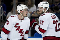 Carolina Hurricanes defenseman Brady Skjei (76) speaks with defenseman Brett Pesce (22) during the second period of Game 6 of an NHL hockey Stanley Cup second-round playoff series, Saturday, May 28, 2022, in New York. (AP Photo/John Minchillo)