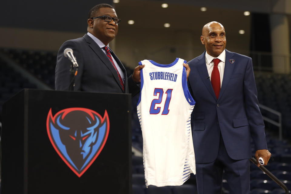 FILE -DePaul University's new men's basketball head coach Tony Stubblefield, right, holds a jersey accompanied by director of athletics DeWayne Peevy, left, during a press conference, Wednesday, April 7, 2021 in Chicago. DePaul athletic director DeWayne Peevy insisted the foundation to turn a struggling men's basketball program into a consistent winner is in place and he decided to fire coach Tony Stubblefield because the results did not match his expectations, Tuesday, Jan. 23, 2024. (AP Photo/Shafkat Anowar, File)