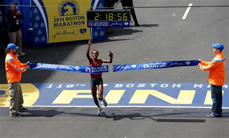 Apr 21, 2014; Boston, MA, USA; Rita Jeptoo (KEN) crosses the finish line to win the women's division of the 2014 Boston Marathon. Greg M. Cooper-USA TODAY Sports