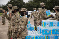 National Guard soldiers distribute bottled water to residents Monday, Sept. 28, 2020, in Lake Jackson, Texas. Texas Gov. Greg Abbott issued a disaster declaration on Sunday after a brain-eating amoeba was discovered in the water supply for Lake Jackson, Texas. The disaster declaration extends across Brazoria County, where Lake Jackson is located. The disaster declaration comes after the death of a 6-year-old boy who was infected by a brain-eating amoeba. (Marie D. De Jesús/Houston Chronicle via AP)