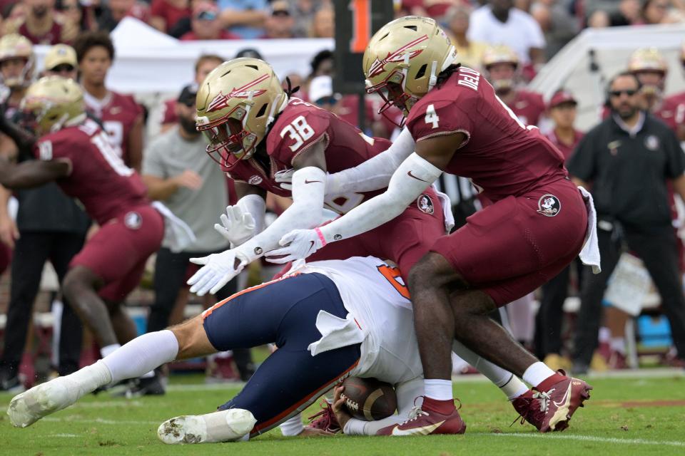 Syracuse quarterback Garrett Shrader is sacked by Florida State defensive back Shyheim Brown (38) and linebacker Kalen DeLoach (4) during the first half of an NCAA college football game, Saturday, Oct. 14, 2023, in Tallahassee, Fla.