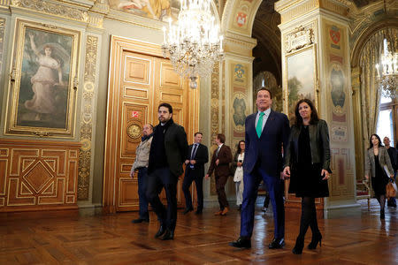 Mayor of Paris Anne Hidalgo (R) and R20 founder and former California state governor Arnold Schwarzenegger arrive to attend a news conference ahead of the One Planet Summit in Paris, France, December 11, 2017. REUTERS/Gonzalo Fuentes