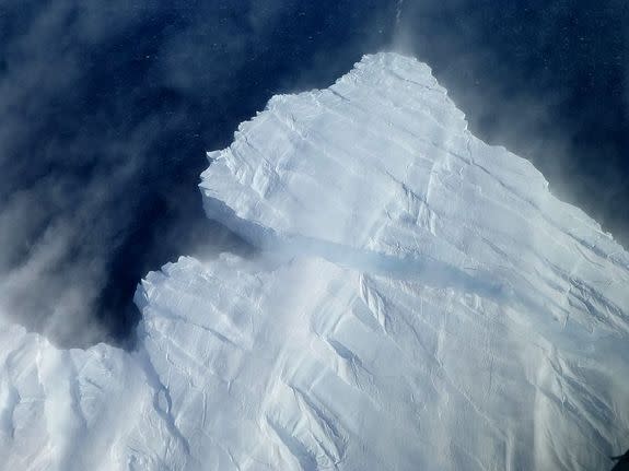 An iceberg breaks off Pine Island Glacier into the Amundsen Sea in West Antarctica.