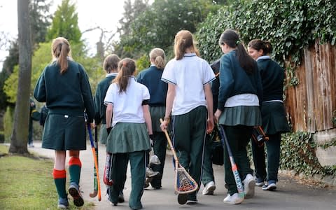 Girls from Cheltenham Ladies' College on their way to hockey and lacrosse practice  - Credit: Adrian Sherratt / Alamy