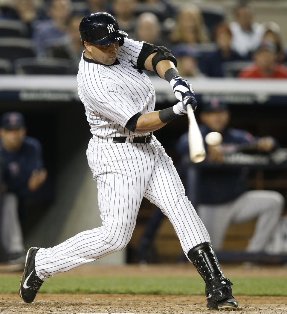 New York Yankees right fielder Carlos Beltran hits a seventh-inning double chasing Boston Red Sox starting pitcher Felix Doubront from a baseball game between the two American League East teams at Yankee Stadium in New York, Sunday, April 13, 2014. (AP Photo/Kathy Willens)